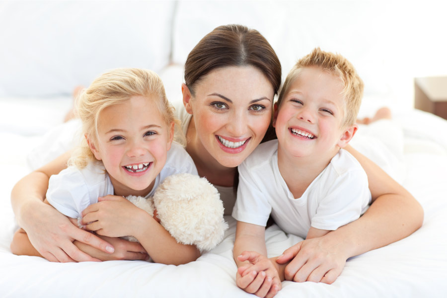 Brunette mother with her two blonde children smile in Fort Smith, AR