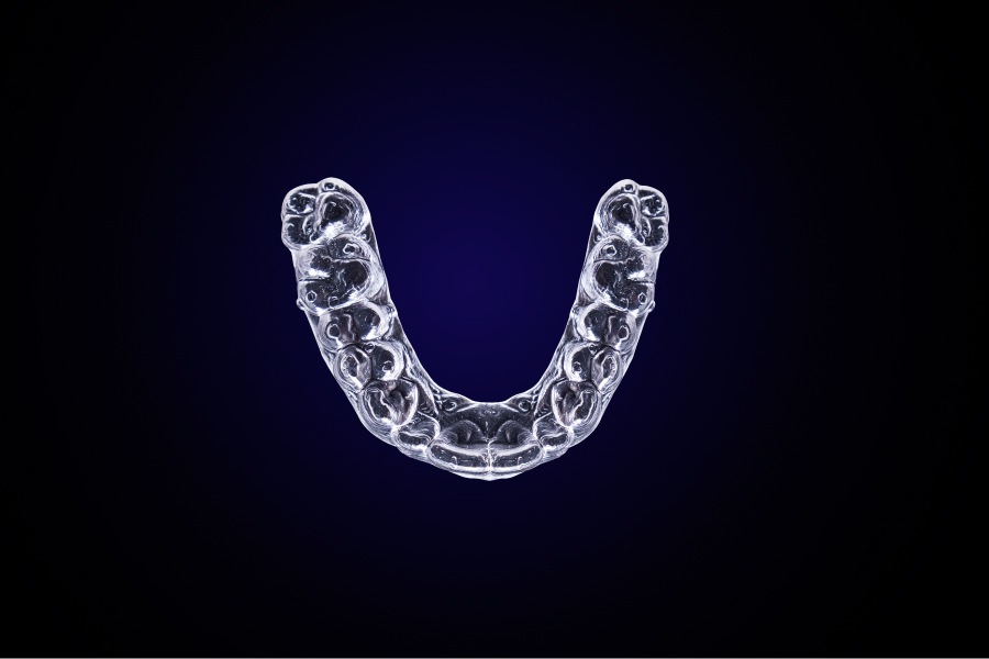 Aerial view of Invisalign aligners against a blue background