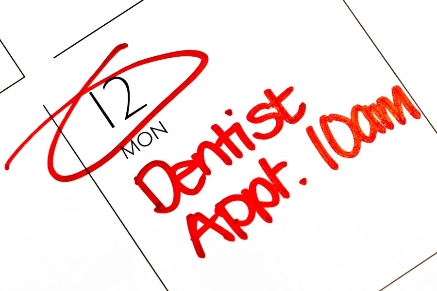 A calendar marked with Dentist Appt. 10 am in red ink as a reminder for a dentist appointment