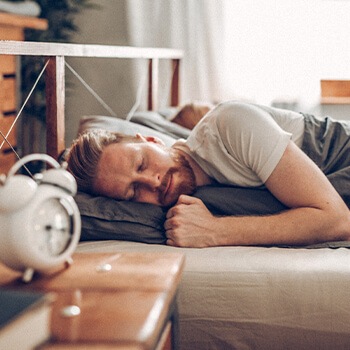 man laying in bed asleep