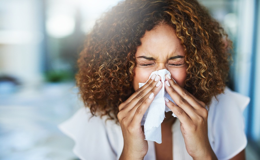 allergies and oral health, sneezing woman