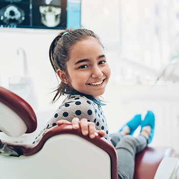 girl sitting in a dental chair