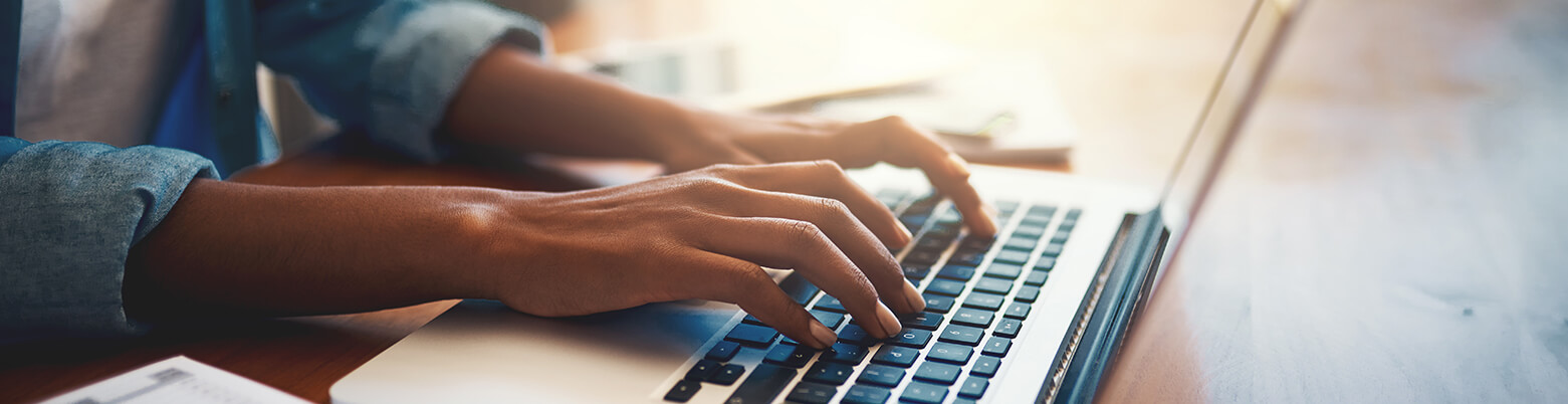 person typing on a laptop